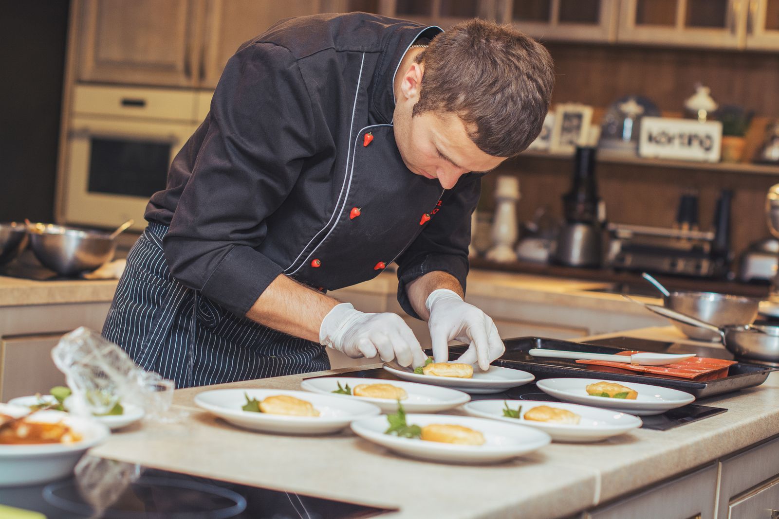 Chef carefully plating a restaurant dish